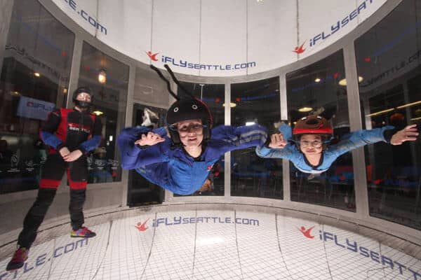 Two Kids Flying Together In Ifly Seattle.