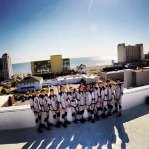 A Photo Of The Instructors In Their Flight Suits On Top Of The Wind Tunnel.