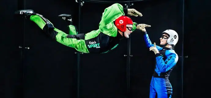 Instructor Working With A First Time Flyer In A Wind Tunnel
