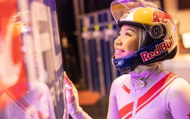 Kyra Poh With Her Hand Against A Wind Tunnel